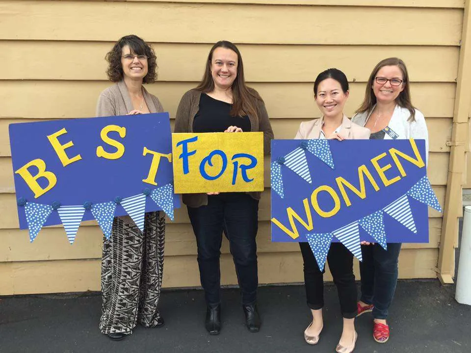 SI Davis members holding Best for Women signs